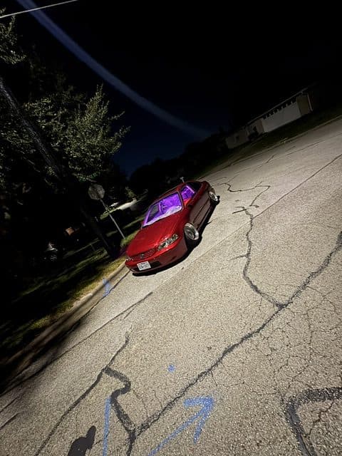 Anthony's red Honda Civic coupe at night with purple interior lights
