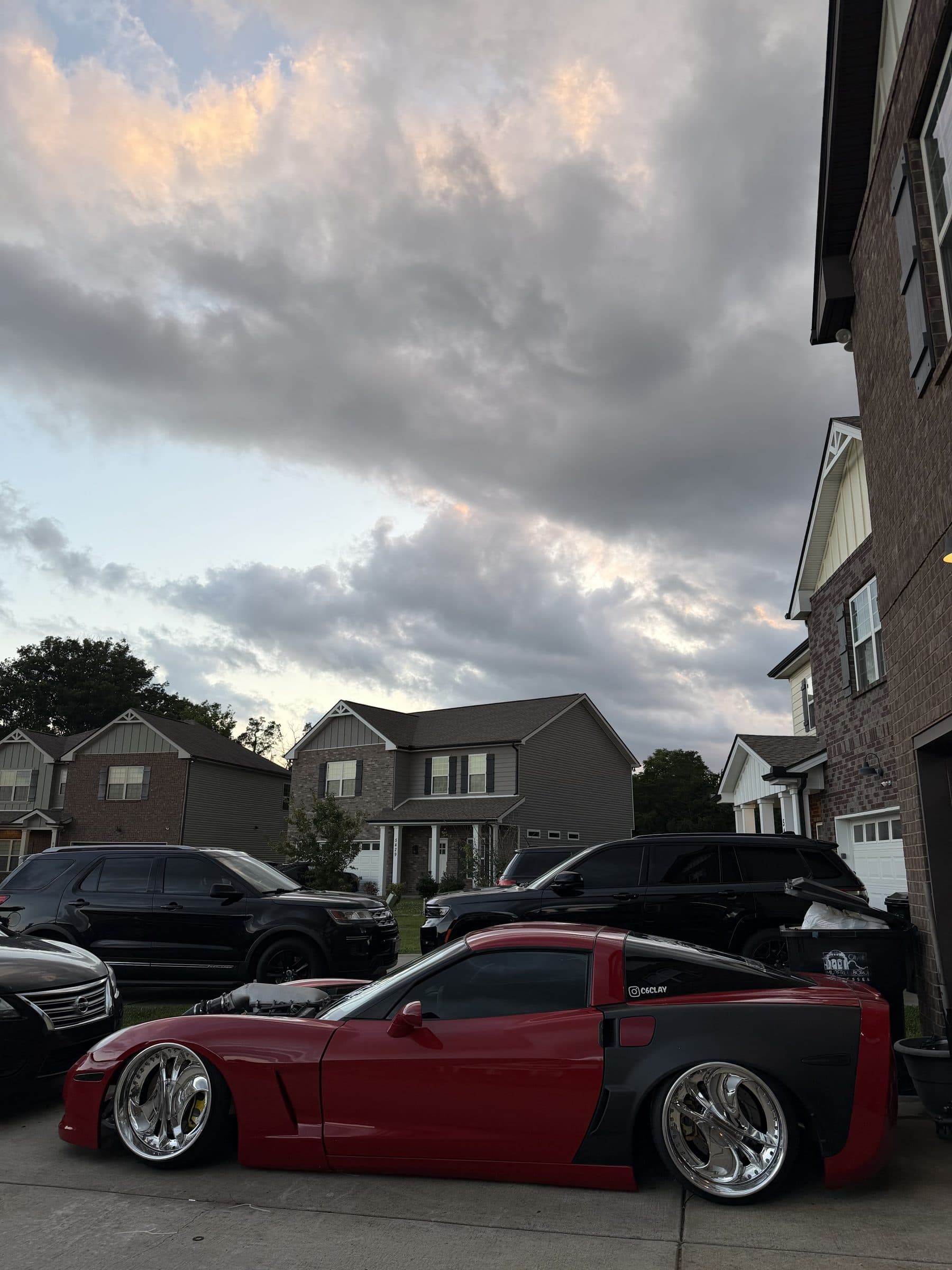 Side profile of Clayton's slammed red C6 Corvette with grey widebody rear fenders