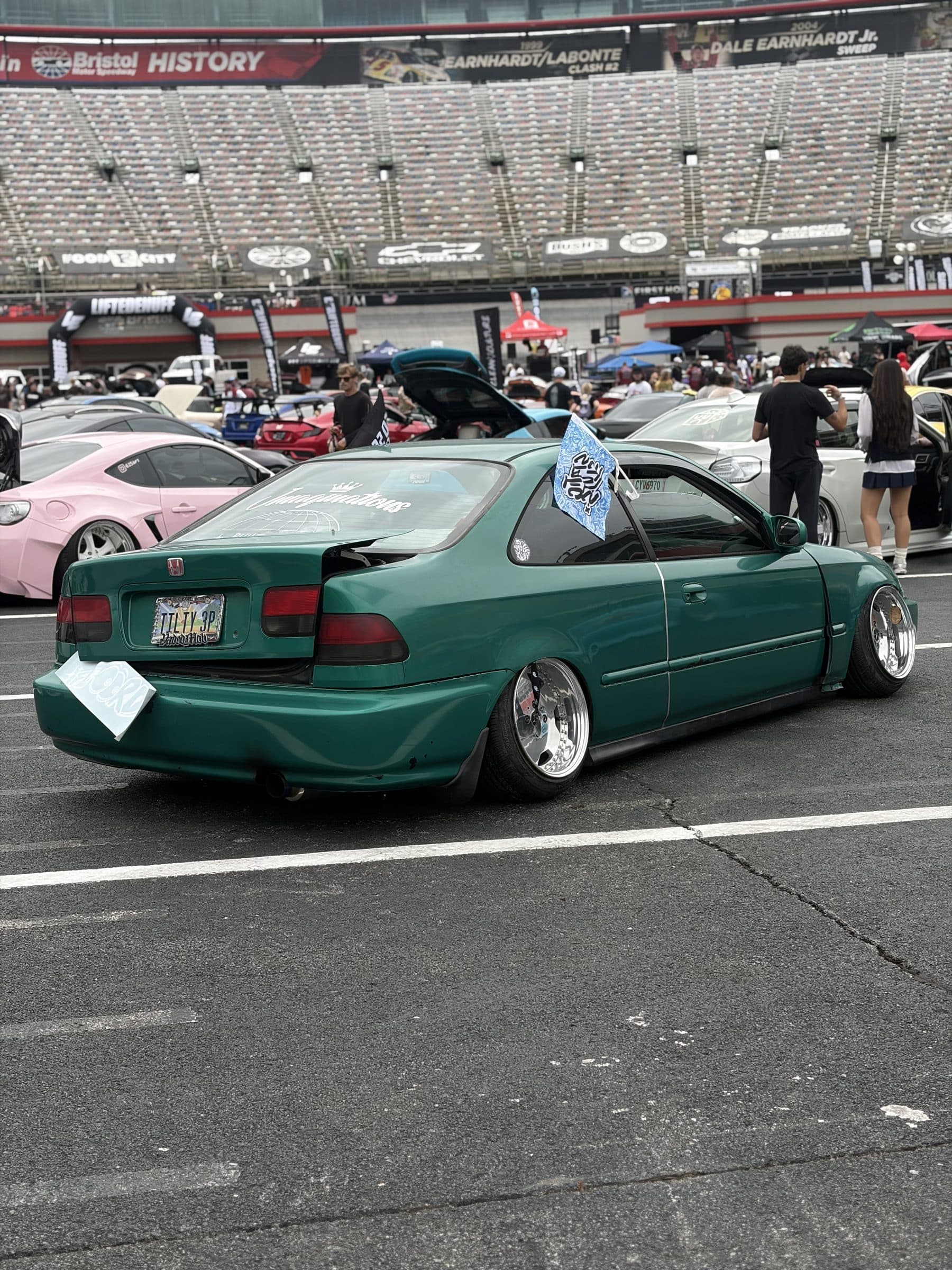 Rear three-quarter view of Garret's green Honda Civic coupe at the speedway