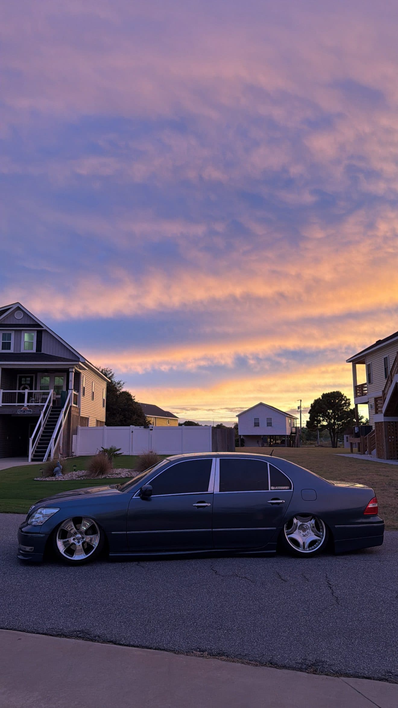 Juan's grey Lexus LS430 parked low on a quiet street at sunset