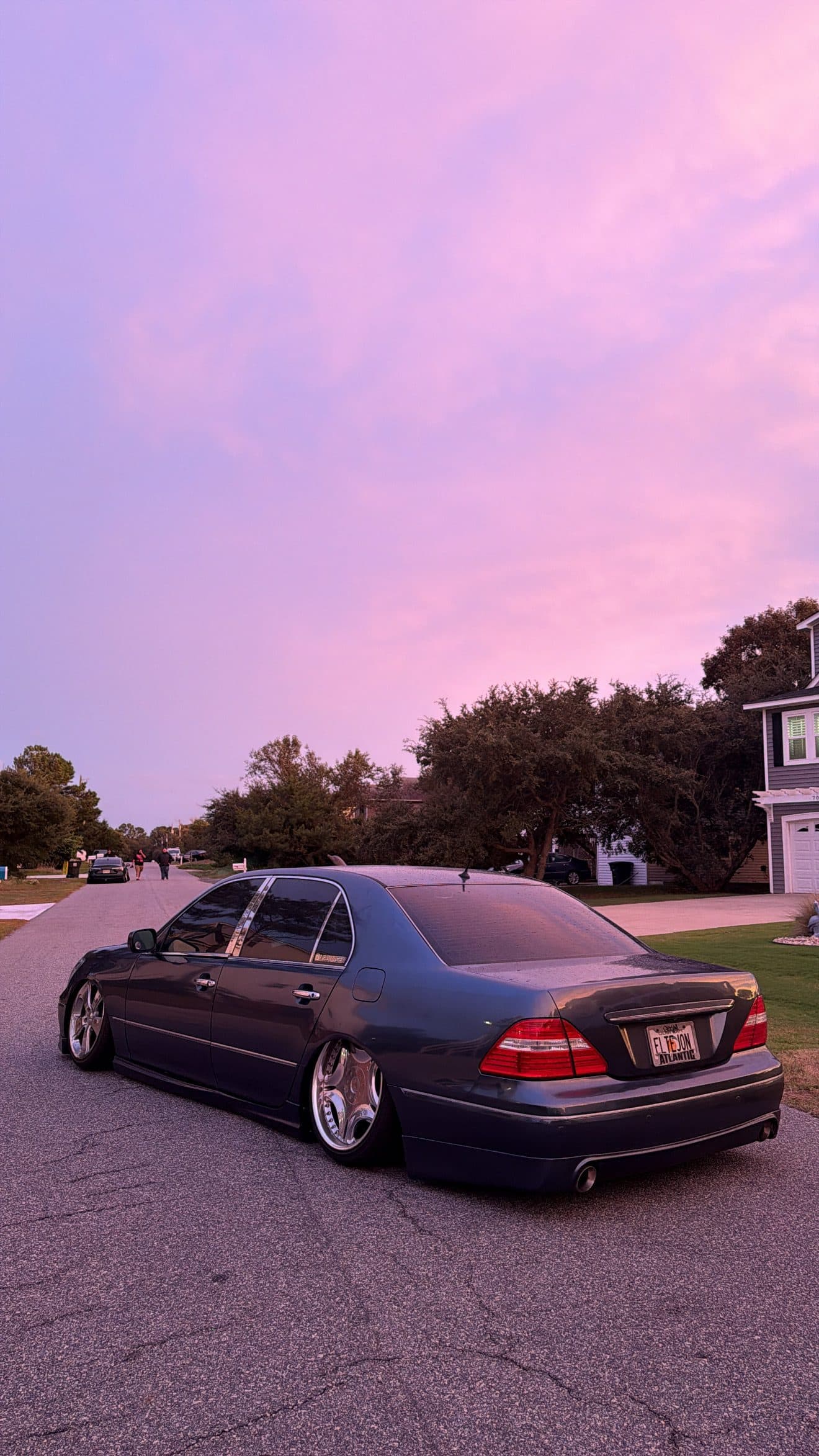 Rear view of Juan's grey Lexus LS430 under a pink sky