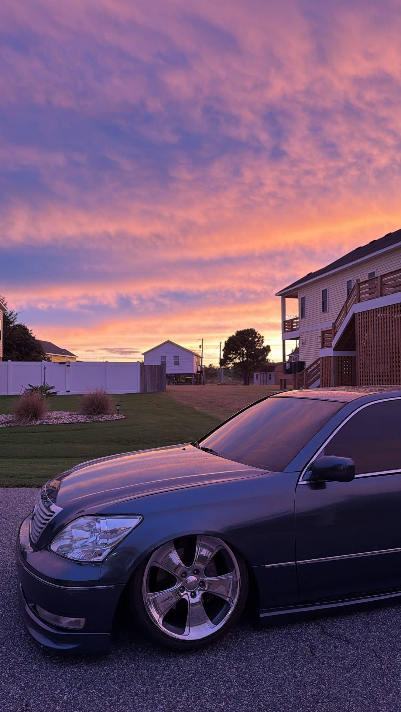 Low front corner of Juan's grey Lexus LS430 at sunset