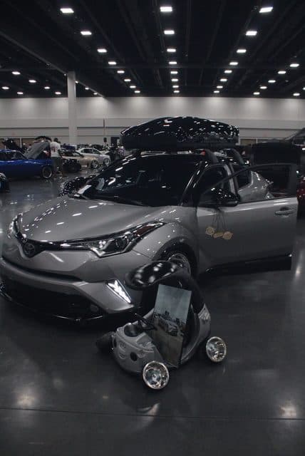 Martinez's silver Toyota C-HR and mini ride-on car at an indoor show