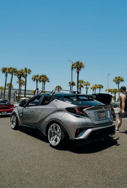 Rear view of Martinez's silver Toyota C-HR under palm trees