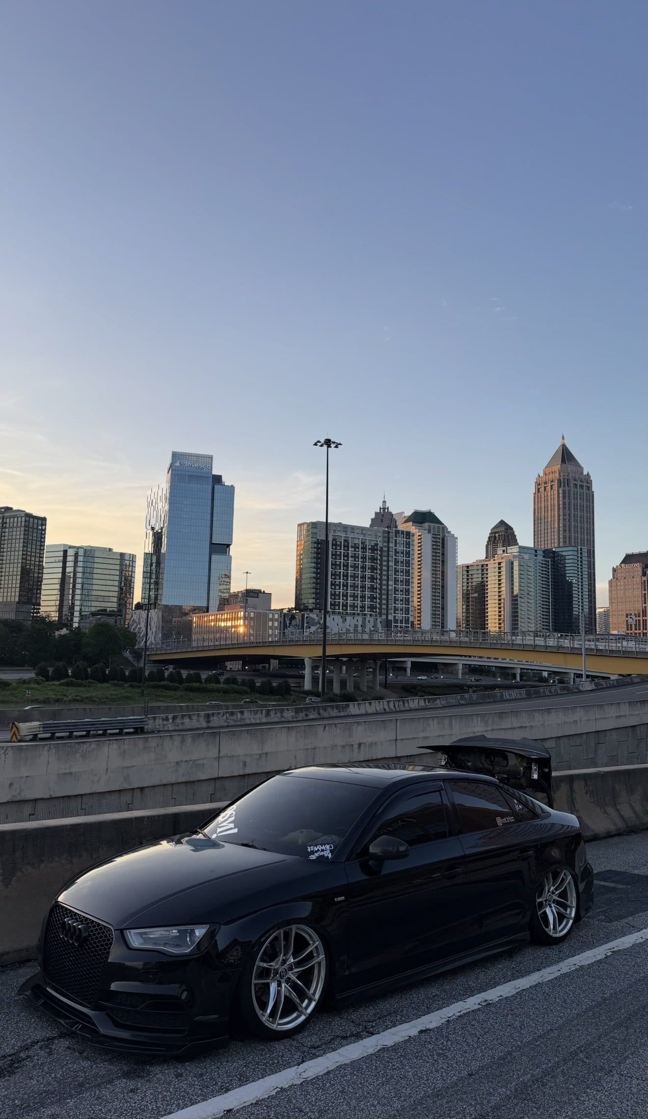 Tristan's black Audi A3 sedan in front of the Atlanta skyline